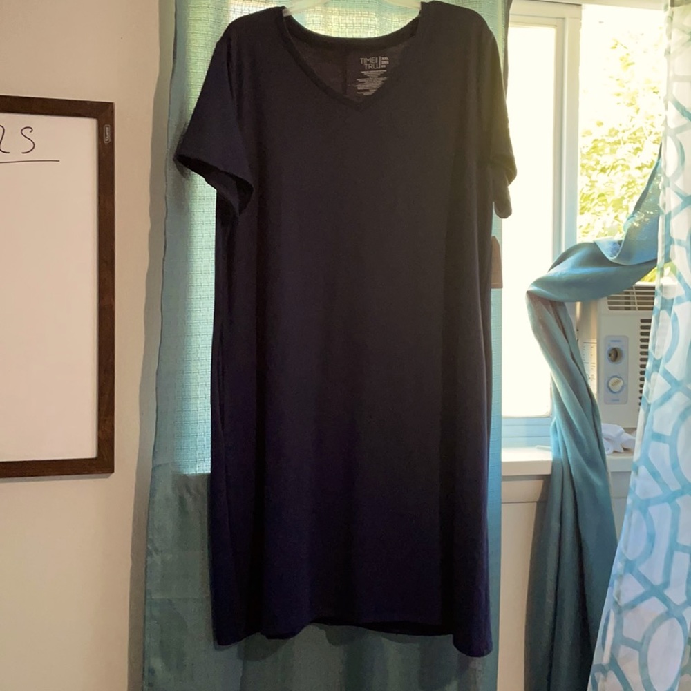 The dress is a below the knees dark blue.